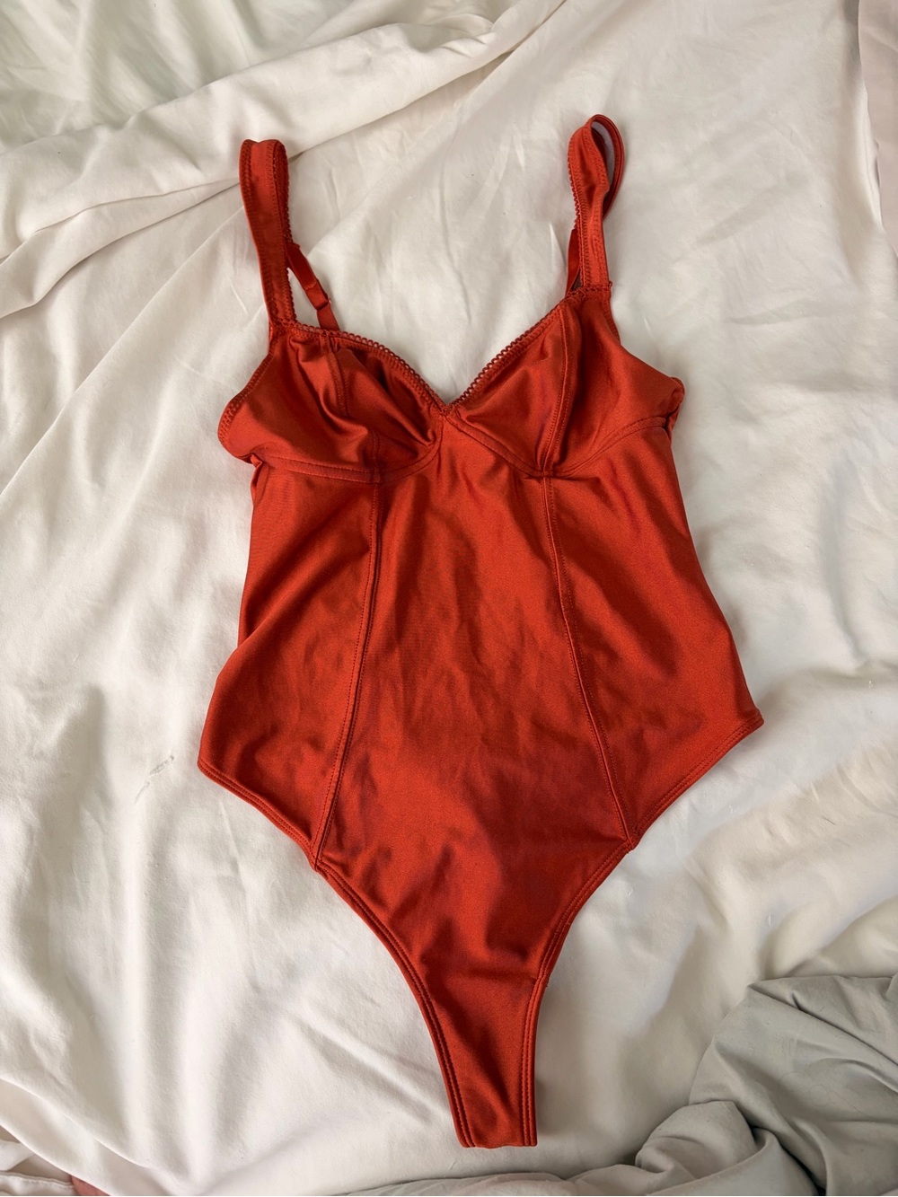 Out from under orange bodysuit
